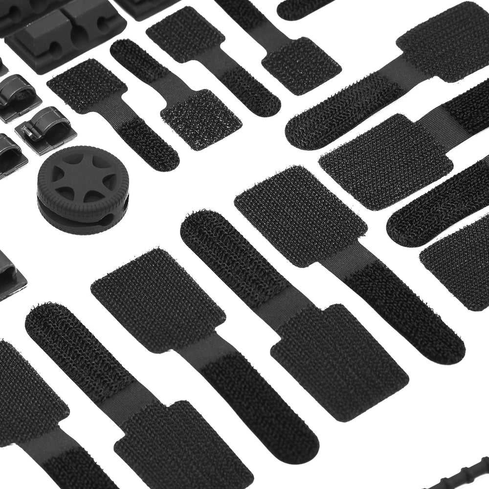 A set of black cable management accessories, including clips, Velcro straps, and a cable organizer wheel, arranged on a white background.