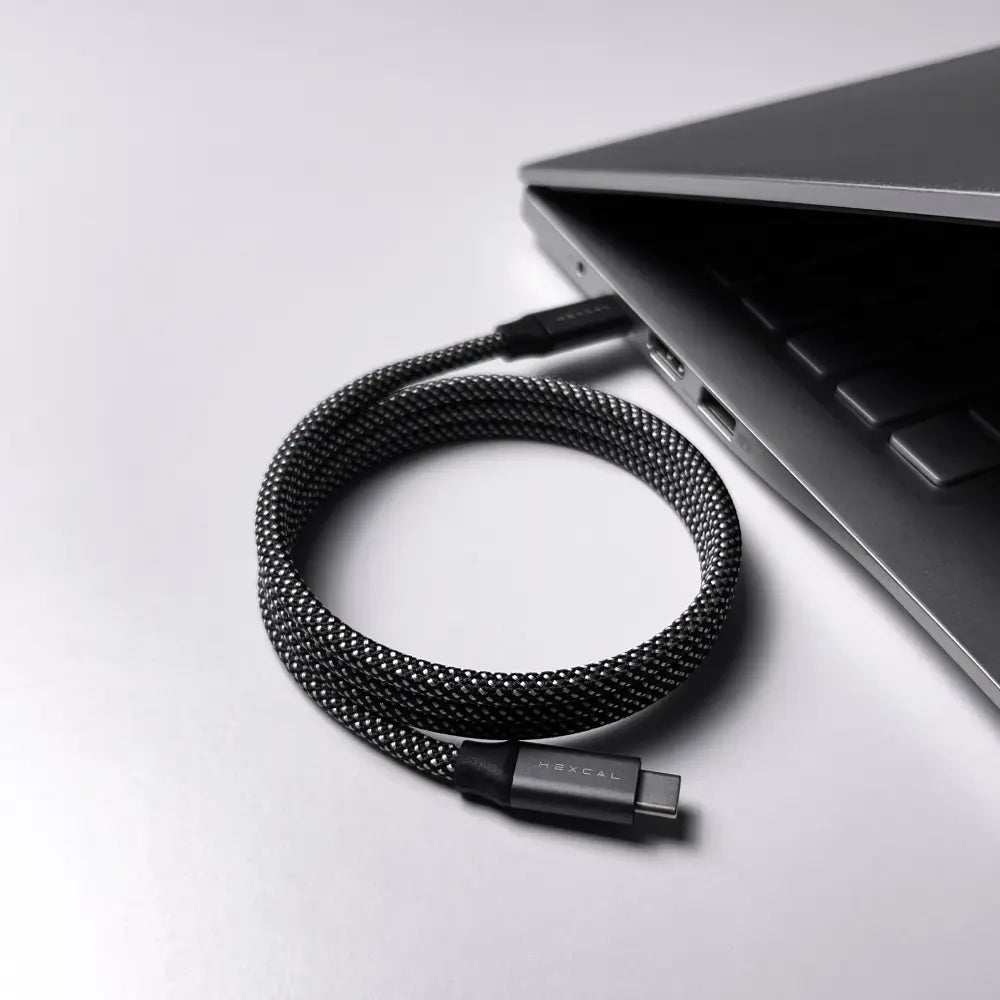 Hexcal Magnetic Charging Cable is connected to a laptop on a desk.