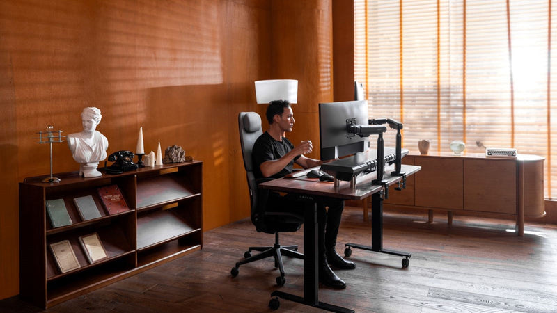 A setup combining a monitor stand and monitor arm offers stability and flexibility, providing precise height and angle adjustments with a stable base for optimal ergonomic positioning.