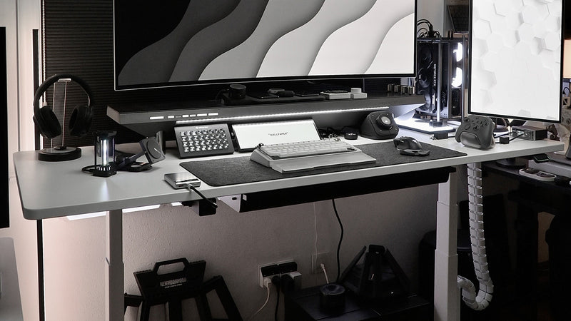 Standing workstation with desktop equipment and floor-level computer placement