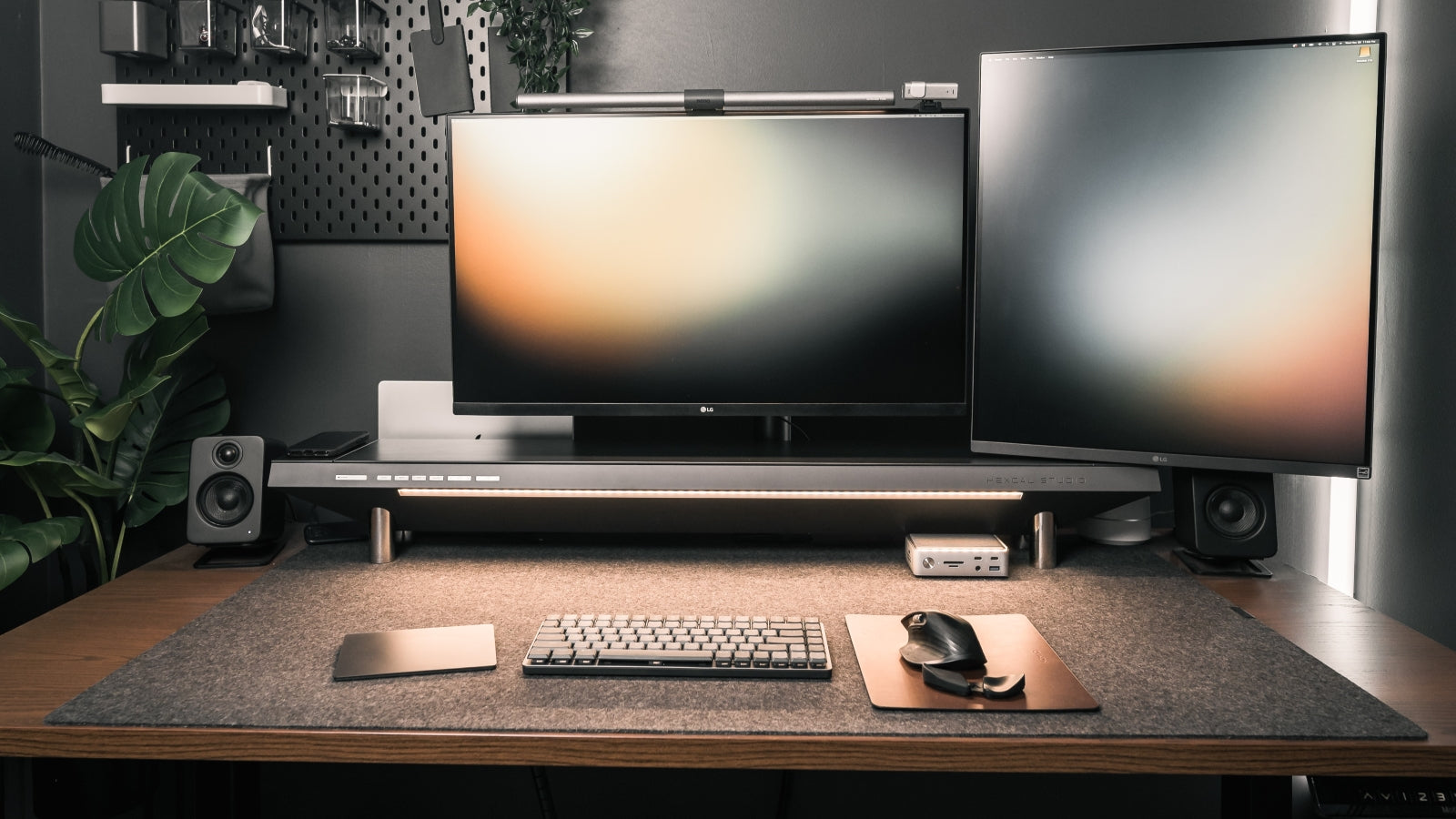 A dual-monitor setup with Hexcal monitor stand and monitor arms.