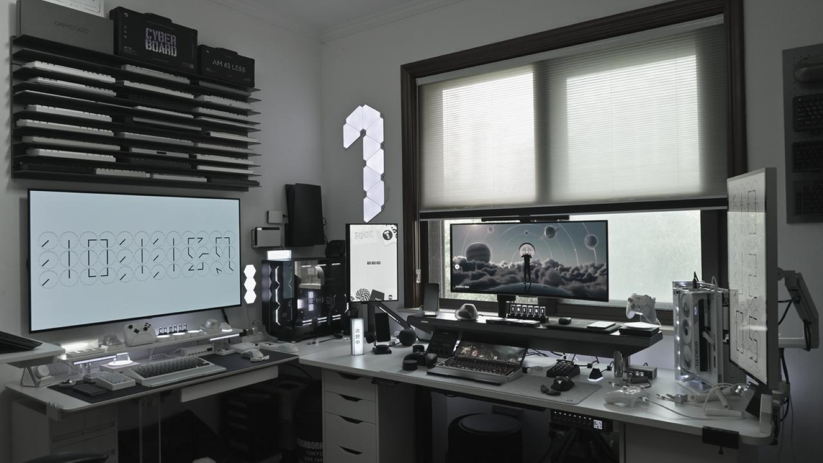 A Hexcal's gaming room with multiple monitors and two difference size desks, featuring Hexcal Studio.