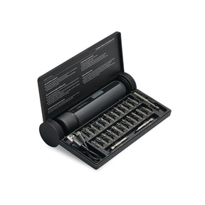 Black screwdriver set with bits in an open case on a white background