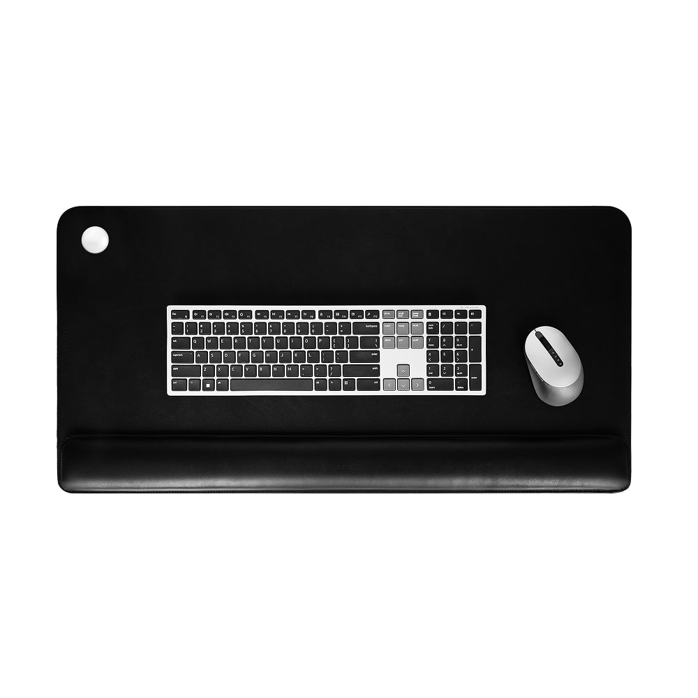 Black desk mat with keyboard and mouse on a white background