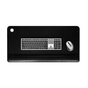 Black desk mat with keyboard and mouse on a white background