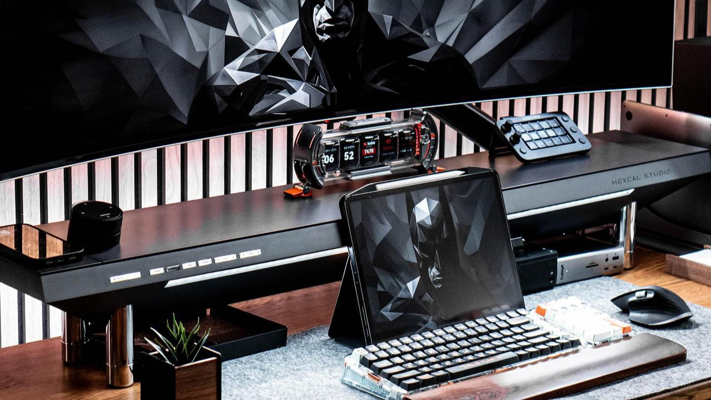 A desk with Samsung Odyssey G9 49" monitor supported by a heavy-duty monitor arm.