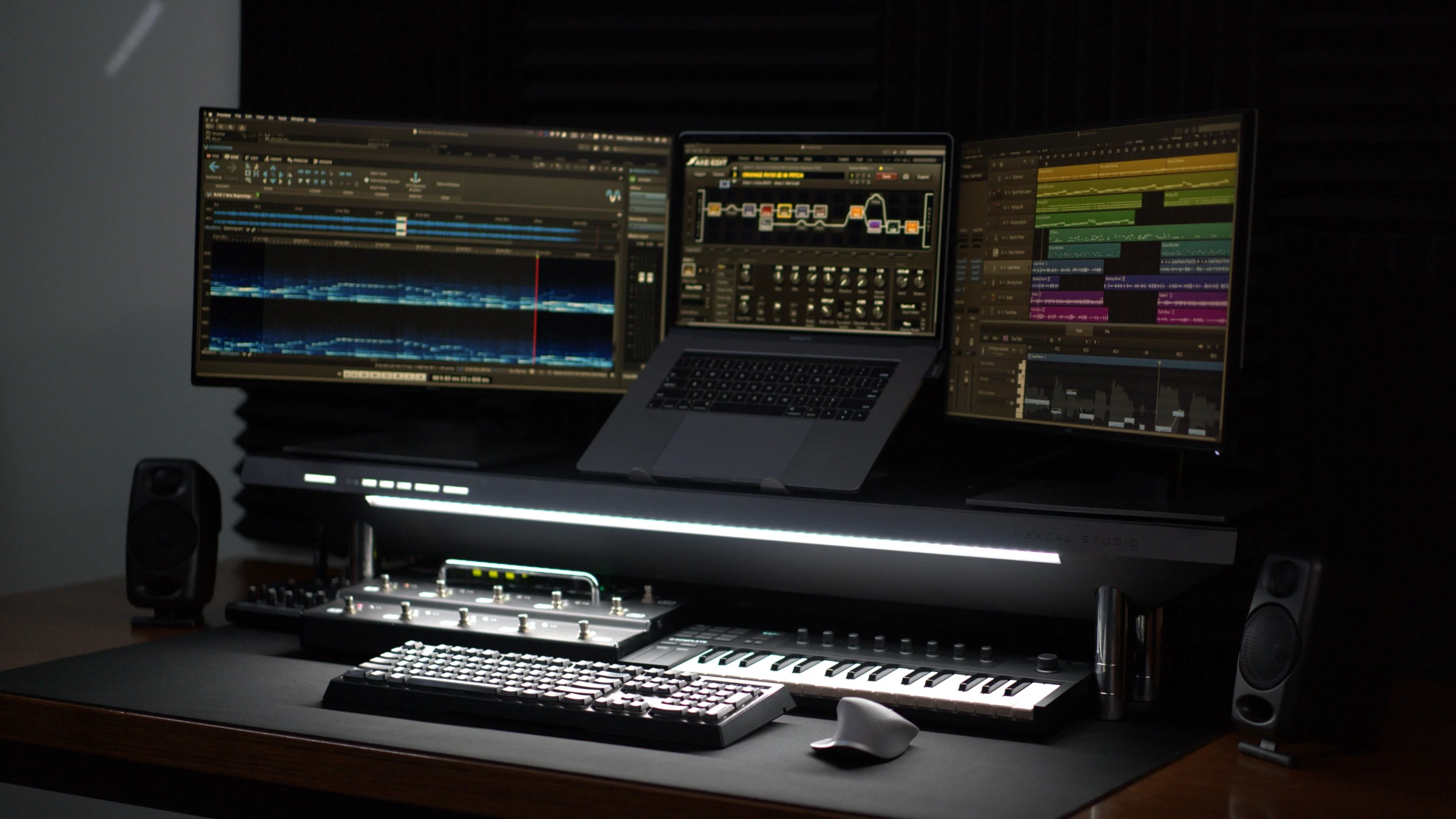 Minimalist multi-monitor desk setup with Hexcal Studio and integrated shadow-free workstation lighting.