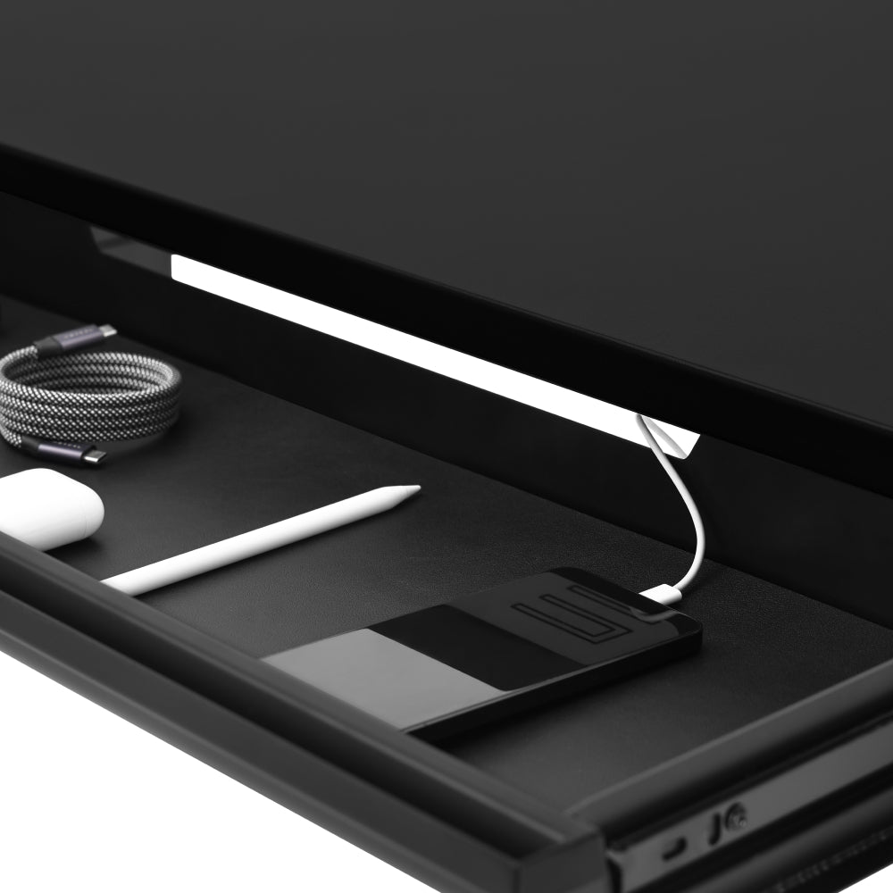 The under-desk drawer keeps documents, cables, and office essentials organised and easily accessible.