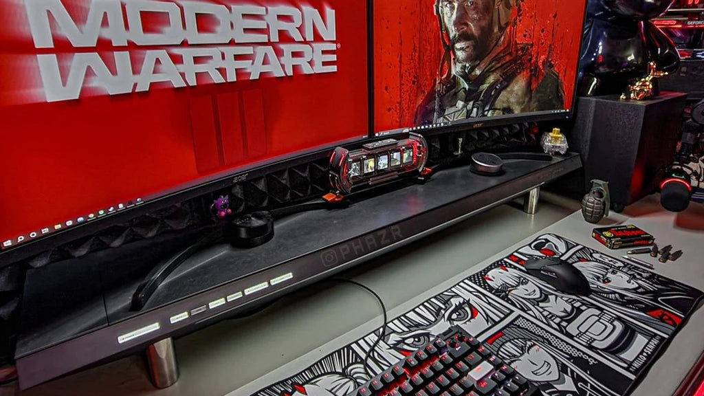 A high-end gaming setup featuring a Hexcal Studio™ desk shelf under dual monitors, paired with a custom anime-themed desk mat.
