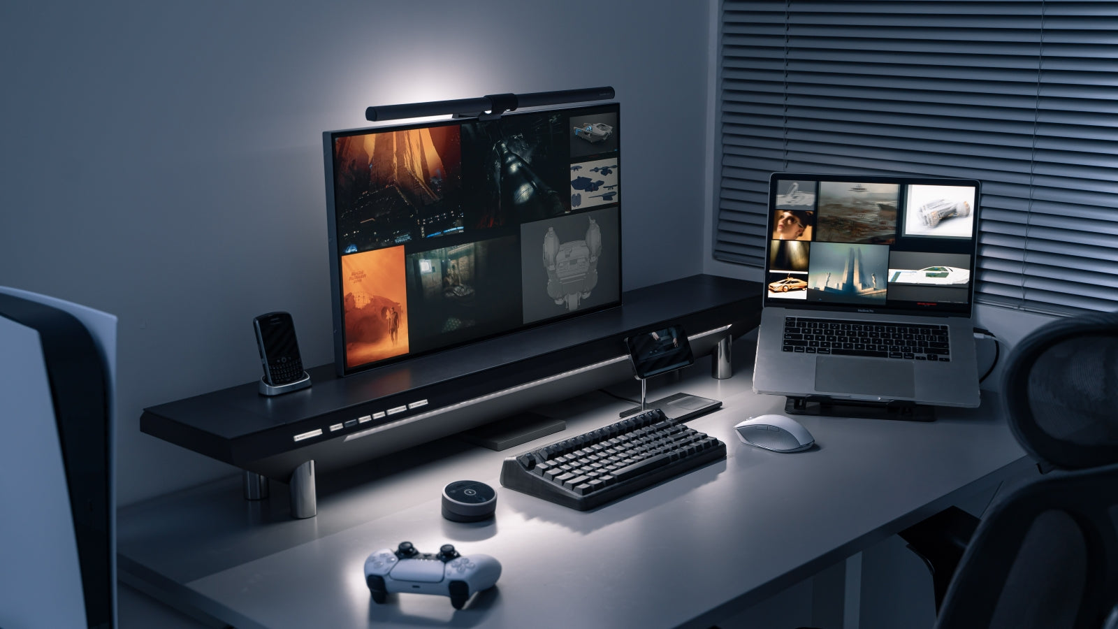 A sleek gaming and productivity setup featuring a monitor on the Hexcal Studio, paired with a laptop, a mechanical keyboard, and a game controller. The ambient lighting and a sci-fi themed background create a futuristic atmosphere in a dimly lit room, showcasing a clean and organized desk ideal for both work and play.
